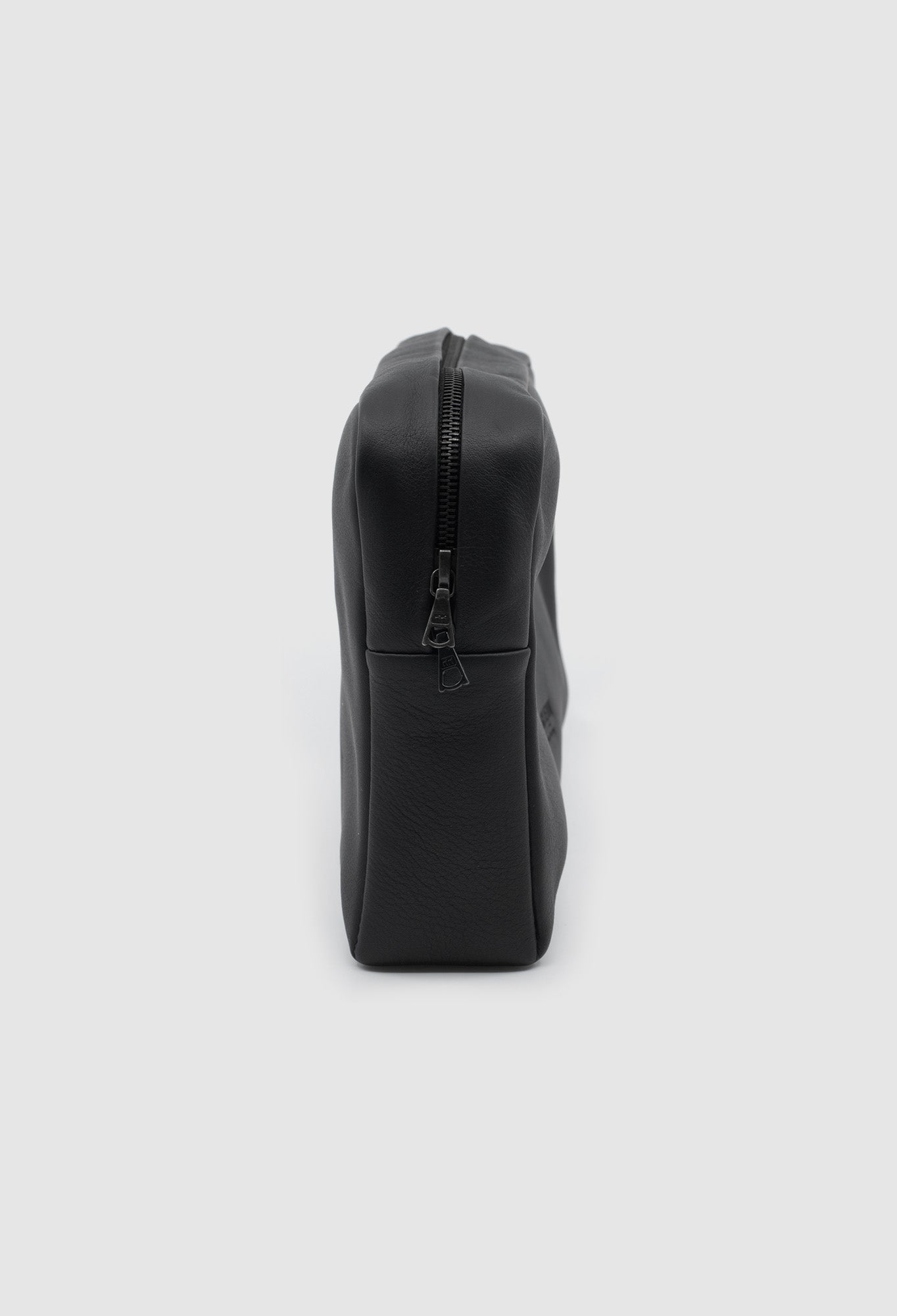 Black leather pouch on a light gray background