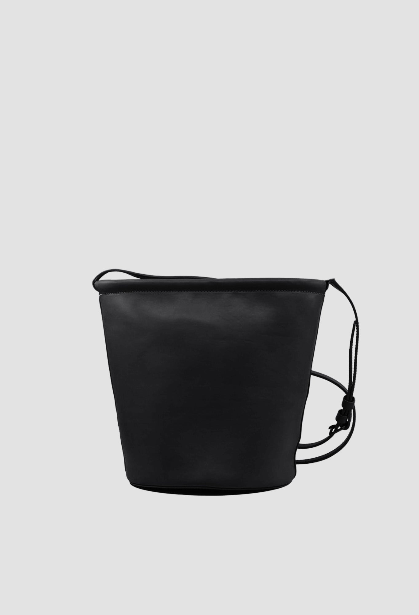 Black drawstring bag on a light gray background