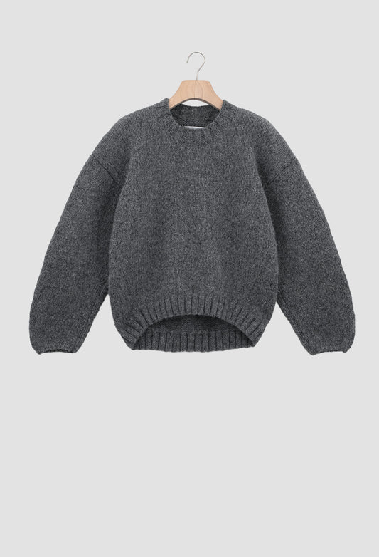 Gray sweater on a hanger against a light gray background