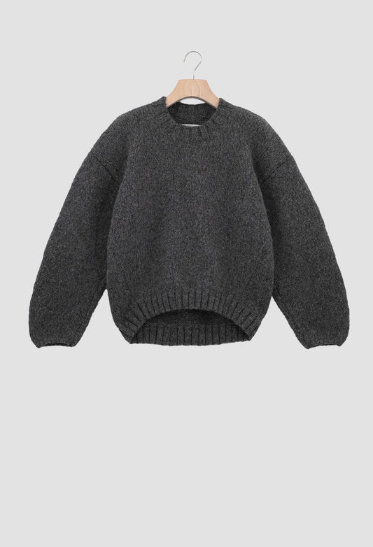 Gray sweater on a hanger against a light gray background