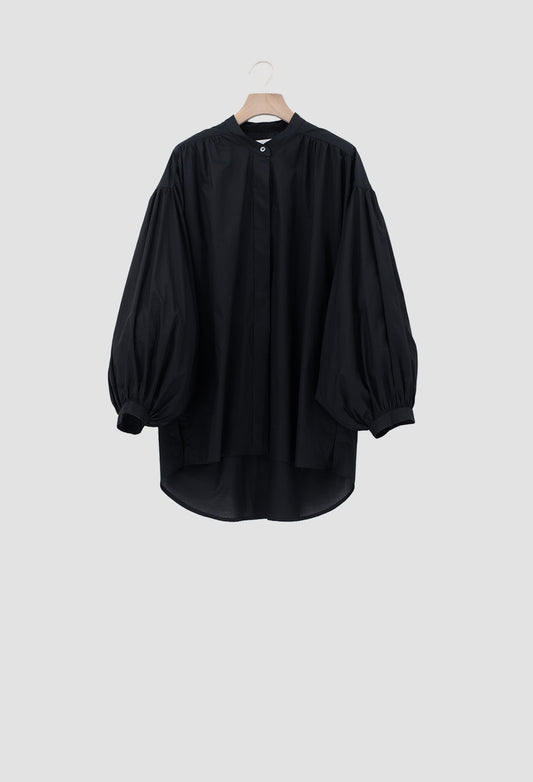 A black long-sleeve blouse with voluminous balloon sleeves and a high round neckline, hanging on a wooden hanger against a light gray background.