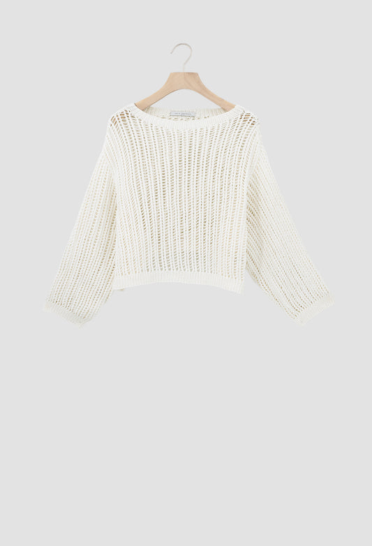 An off-white open-knit cropped sweater with long sleeves, hanging on a wooden hanger against a light gray background.