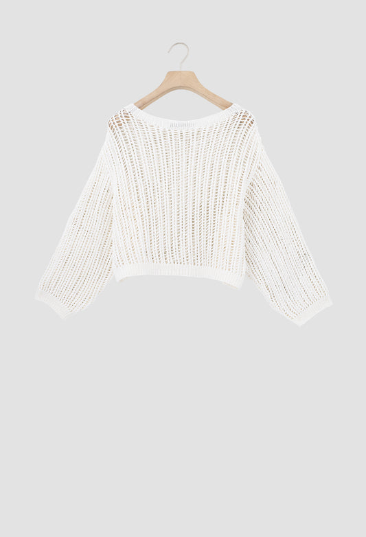 An off-white open-knit cropped sweater with three-quarter sleeves, hanging on a wooden hanger against a solid light gray background.