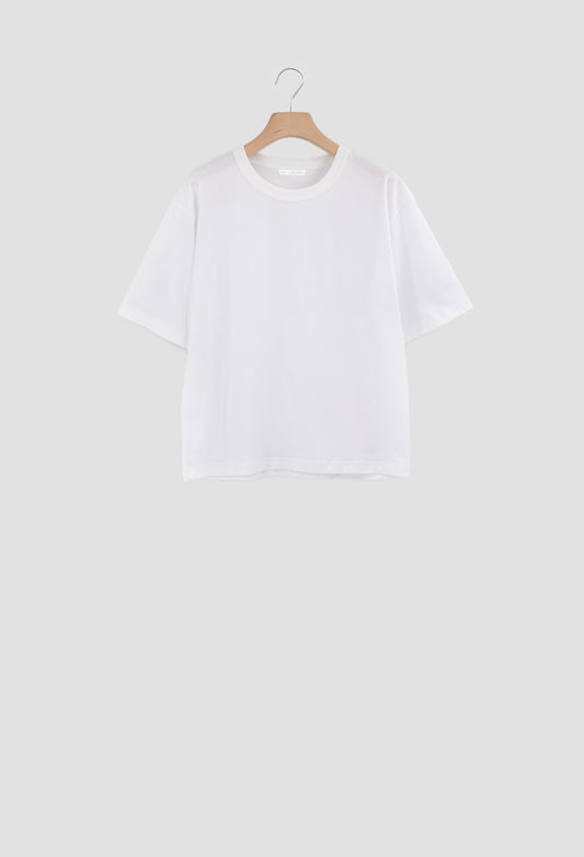 White t-shirt on a wooden hanger against a white background