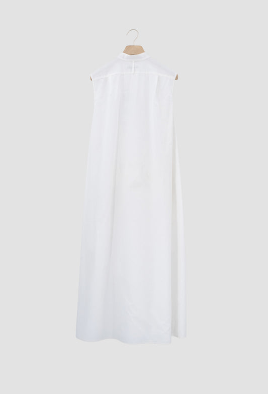 Ivory Sleeveless cotton batiste dress with asymmetrical hem and metal button closures.