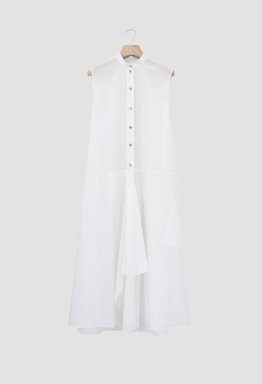 Ivory Sleeveless cotton batiste dress with asymmetrical hem and metal button closures.