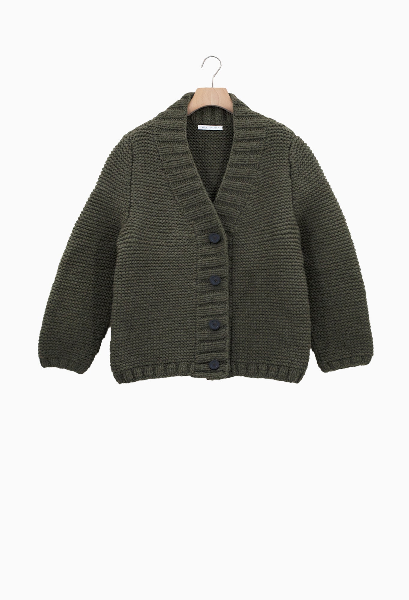 Green knitted cardigan on a hanger against a white background