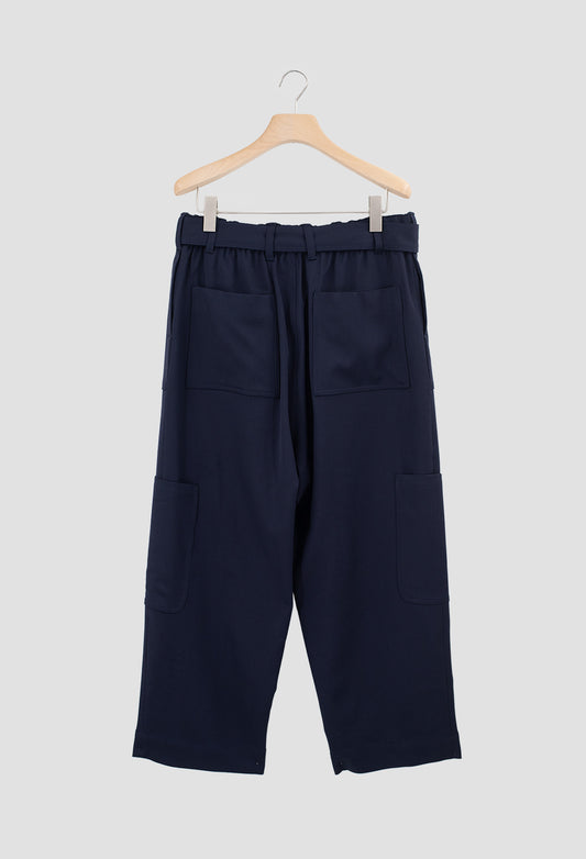 Navy blue pants on a hanger against a light gray background