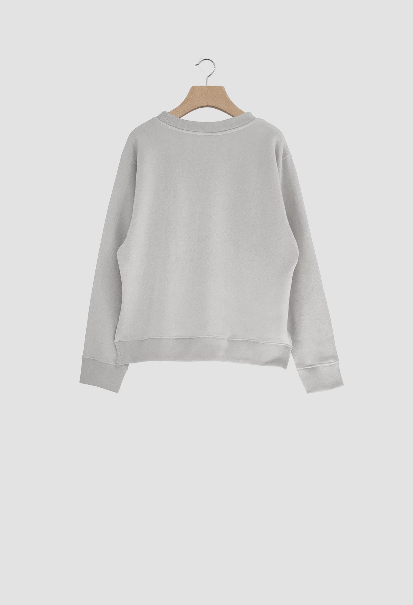 Gray sweatshirt on a wooden hanger against a white background
