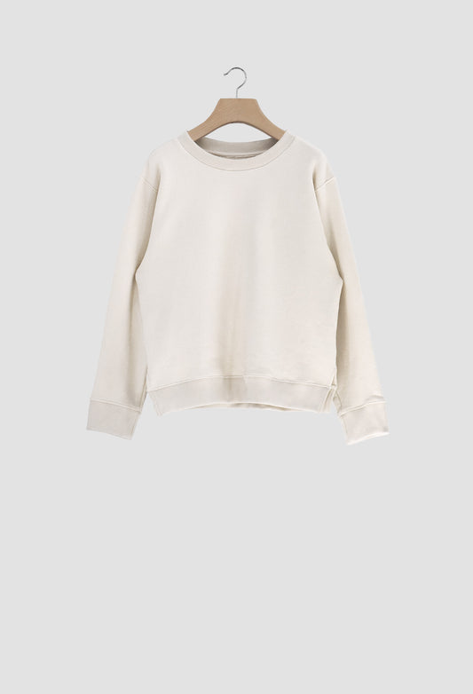 White sweater on a wooden hanger against a light gray background