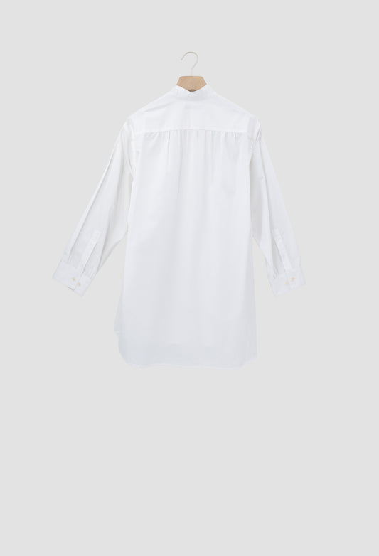 A white long-sleeve button-up shirt shown from the back, hanging on a wooden hanger against a light gray background.
