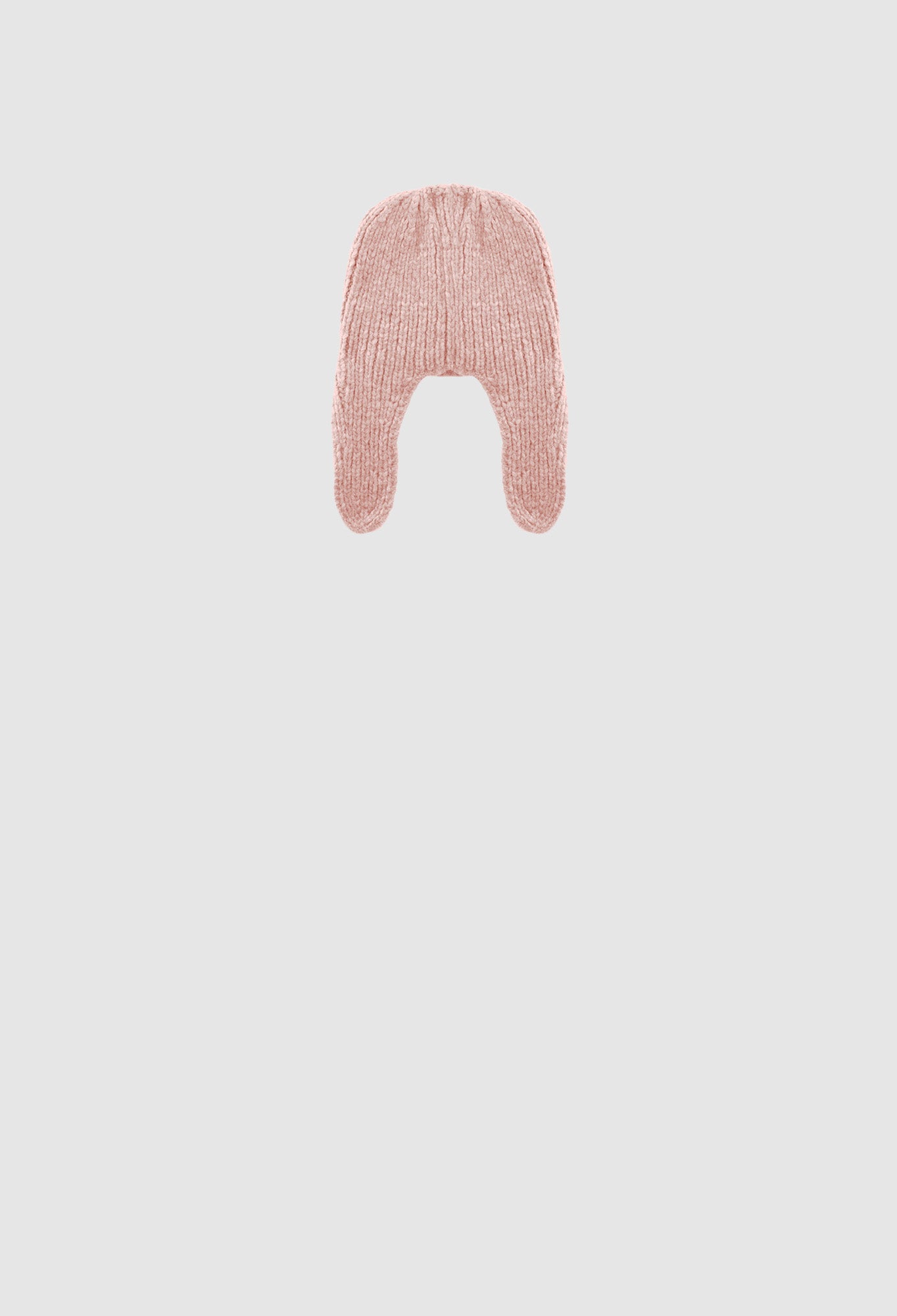 Pink knitted hat on a light gray background