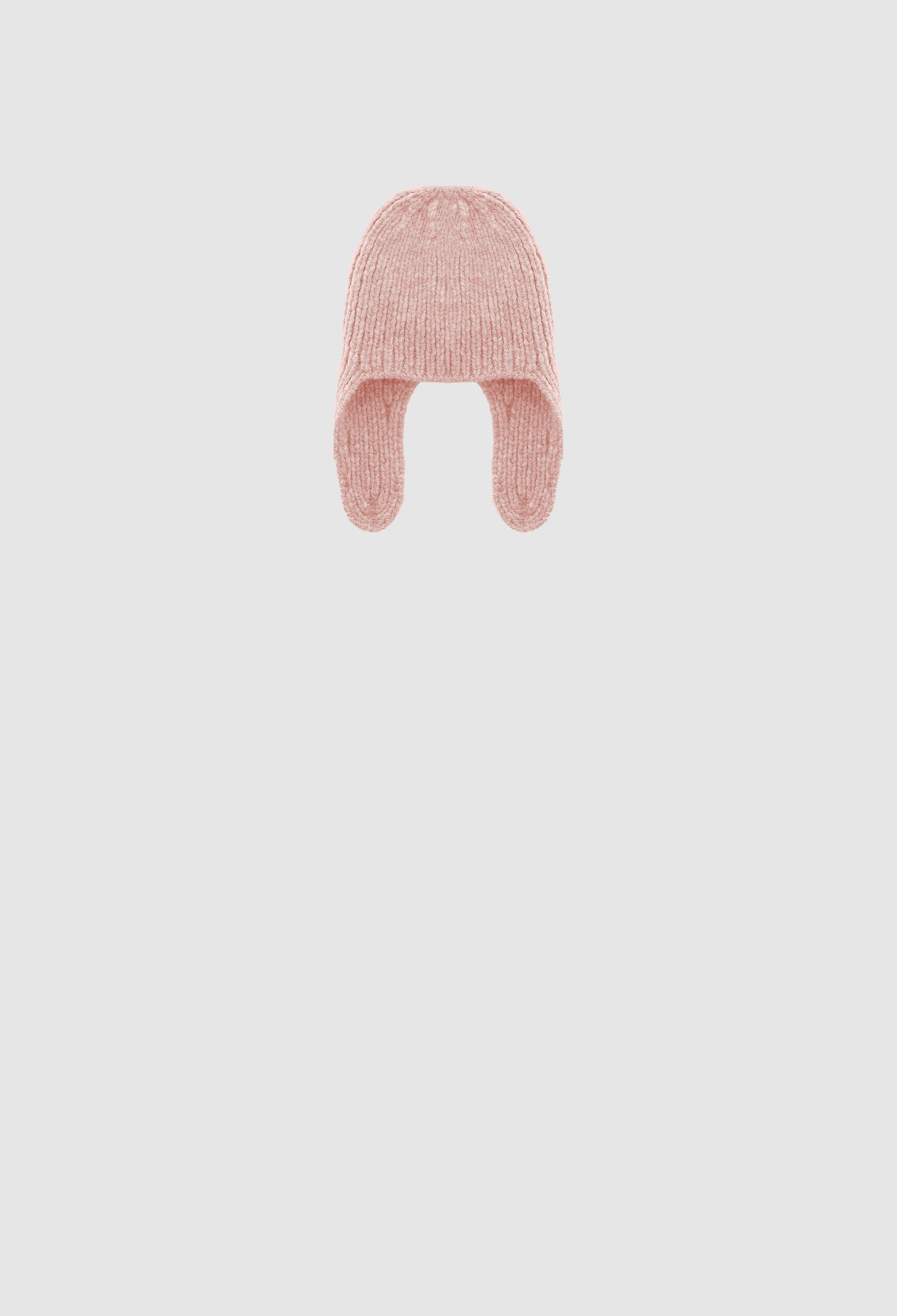 Pink knitted baby hat on a light gray background